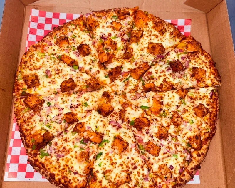 Achari Paneer Pizza topped with homemade achari sauce and paneer at City South Pizza Winnipeg